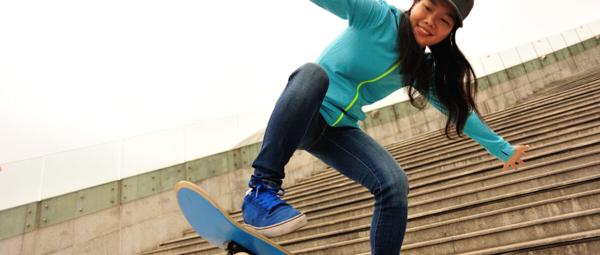 skateboarding woman prepare for jump on stairs